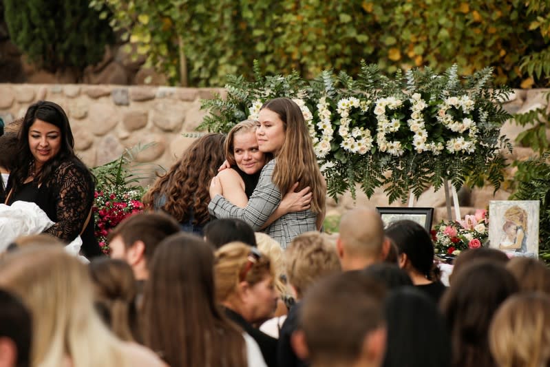 Relatives embrace during the funeral service of Rhonita Miller and her children Howard, Kristal, Titus and Teana, who were killed by unknown assailants, during their funeral service in La Mora