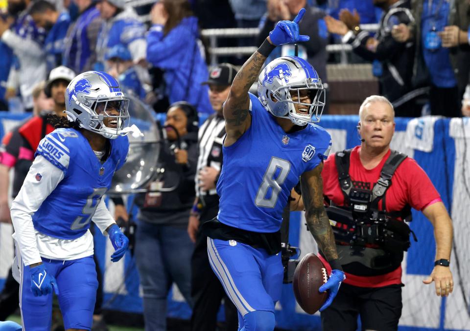 Detroit Lions wide receiver Josh Reynolds runs with the football to celebrate with fans after scoring the first touchdown of the game making the score 10-7 during the first half against the Tampa Bay Buccaneers in the NFC Divisional Playoff at Ford Field in Detroit on Sunday, Jan. 21 2024.