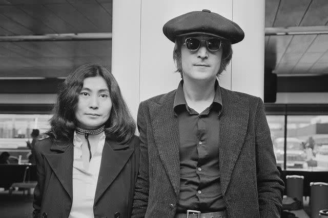 <p>R. Brigden/Daily Express/Getty</p> John Lennon and Yoko Ono arrive at London airport from New York in 1971