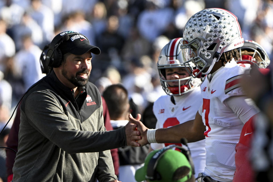 Ohio State head coach Ryan Day celebrates a touchdown with quarterback C.J. Stroud during the fourth quarter of an NCAA college football game against Penn State, Saturday, Oct. 29, 2022, in State College, Pa. Ohio State won 44-31. (AP Photo/Barry Reeger)