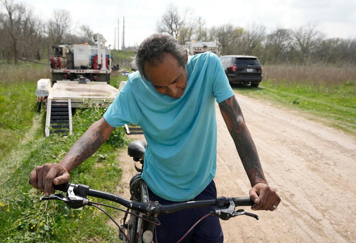 Mario Fonseca, who has been homeless for 15 years, rests while pulling a cart with his belongings after he was removed in a sweep of a homeless encampment in Southeast Austin near East Slaughter Lane and Onion Creek, Monday March 4. (Credit: Jay Janner/American-Statesman)