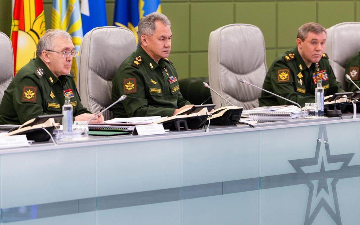 Defence minister Sergei Shoigu, centre, orders top brass to develop a new hypersonic missile and modify an exisiting cruise missile for land use - TASS