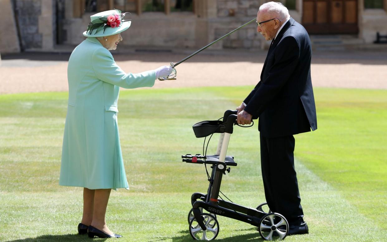 Queen Elizabeth II awards Captain Sir Thomas Moore with the insignia of Knight Bachelor at Windsor Castle on July 17, 2020 in Windsor, England. British World War II veteran Captain Tom Moore raised over Â£32 million for the NHS during the coronavirus pandemic - Chris Jackson