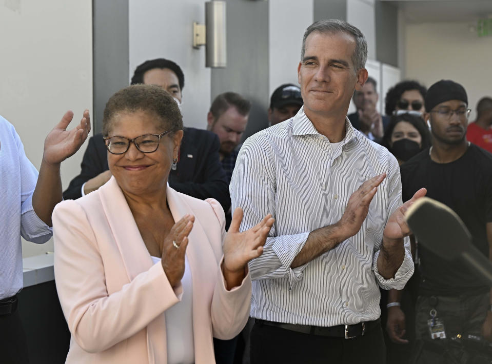 FILE - Los Angeles Mayor Eric Garcetti along with U.S. Rep. Karen Bass visit a Homekey site along Pico Boulevard as he announces awards for homeless housing projects across the state in Los Angeles on Wednesday, Aug. 24, 2022. Karen Bass, the first Black woman elected Los Angeles mayor, will be sworn-in as the 43rd Mayor of Los Angeles by Vice President Kamala Harris in an historic ceremony on Sunday, Dec. 11. (Keith Birmingham/The Orange County Register via AP, File)