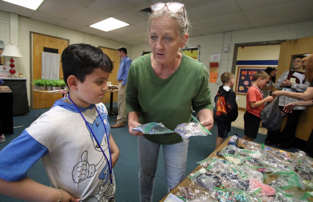 Susan Eason helps Jeremy Leiva choose a gift as a group of 2nd graders look to pick out a free gift to give for Mother’s Day Tuesday morning, May 7, 2024, at Cherryville Elementary School.