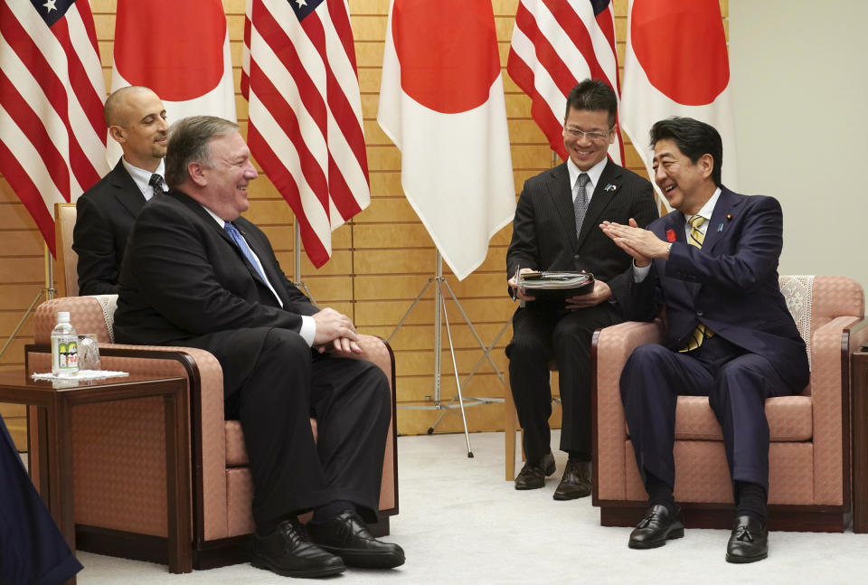 U.S. Secretary of State Mike Pompeo, left, and Japanese Prime Minister Shinzo Abe, right, speak during a meeting at Abe's office in Tokyo Saturday, Oct. 6, 2018. Pompeo has arrived in Tokyo for talks with Japanese officials ahead of his trip to North Korea. (AP Photo/Eugene Hoshiko, Pool)