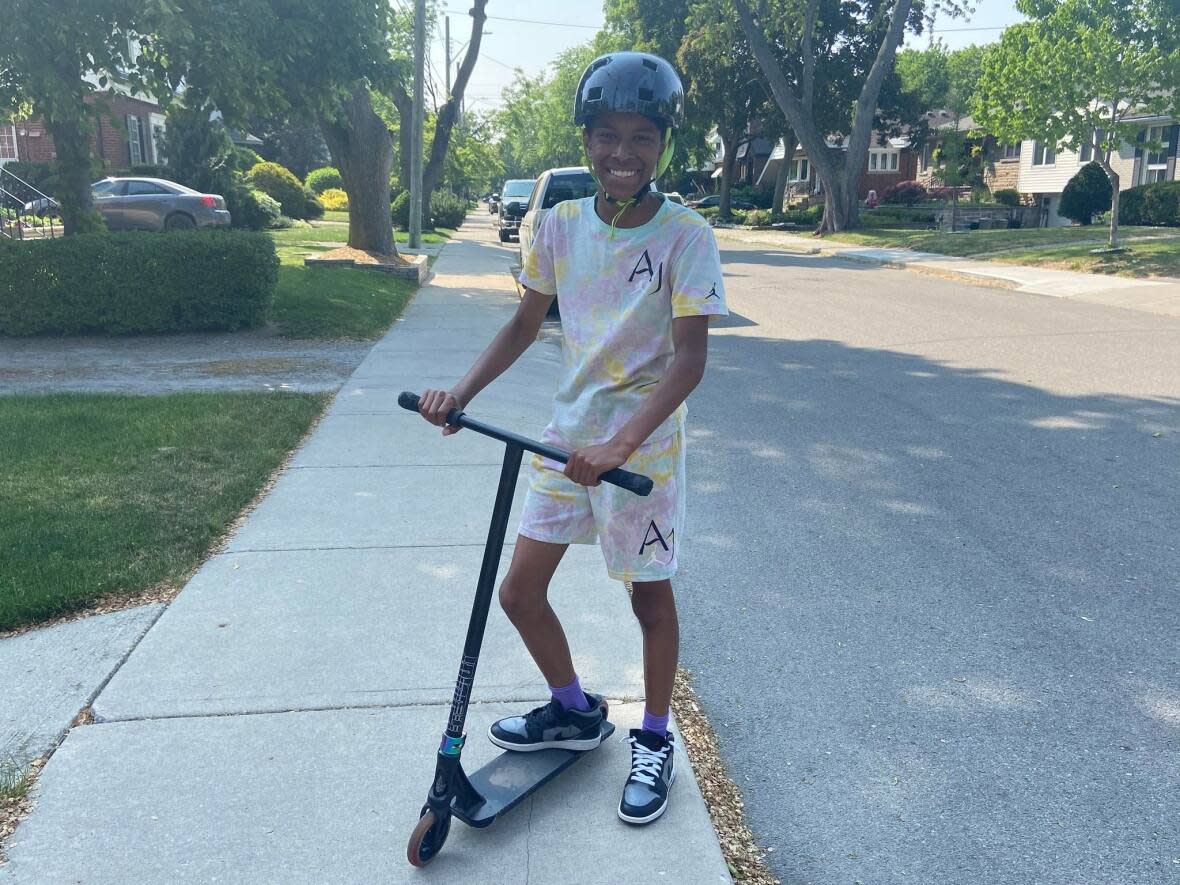 Kail Dutt, 11, is looking forward to riding his scooter on the soon-to-be constructed pump track in Whitney Pier, N.S. (Monika Dutt - image credit)