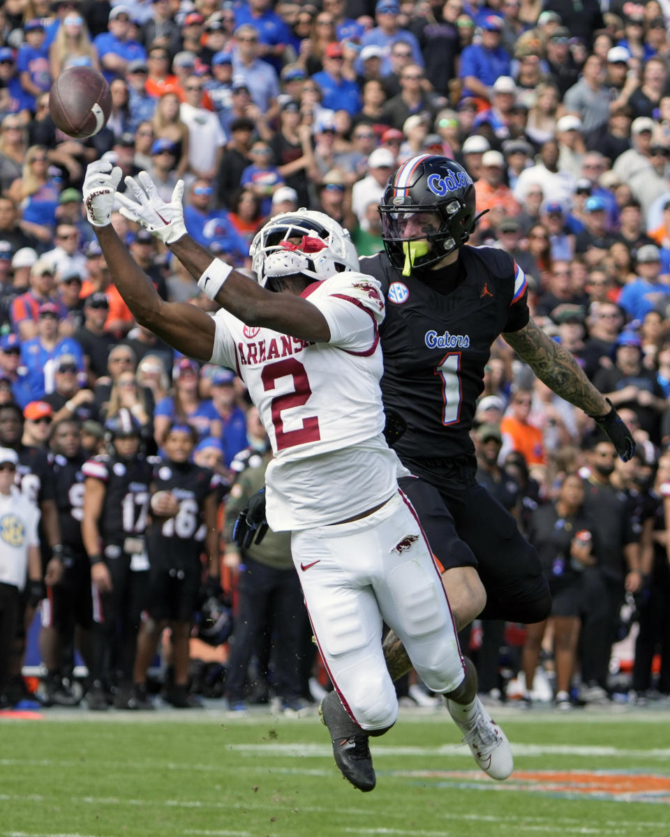 Arkansas defensive back Dwight McGlothern (2) breaks up a pass intended for Florida wide receiver Ricky Pearsall (1) during the first half of an NCAA college football game, Saturday, Nov. 4, 2023, in Gainesville, Fla. (AP Photo/John Raoux)