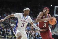 Ta3 tries to get past Kansas' Dajuan Harris Jr. during the second half of a second-round college basketball game in the NCAA Tournament Saturday, March 18, 2023, in Des Moines, Iowa. (AP Photo/Morry Gash)