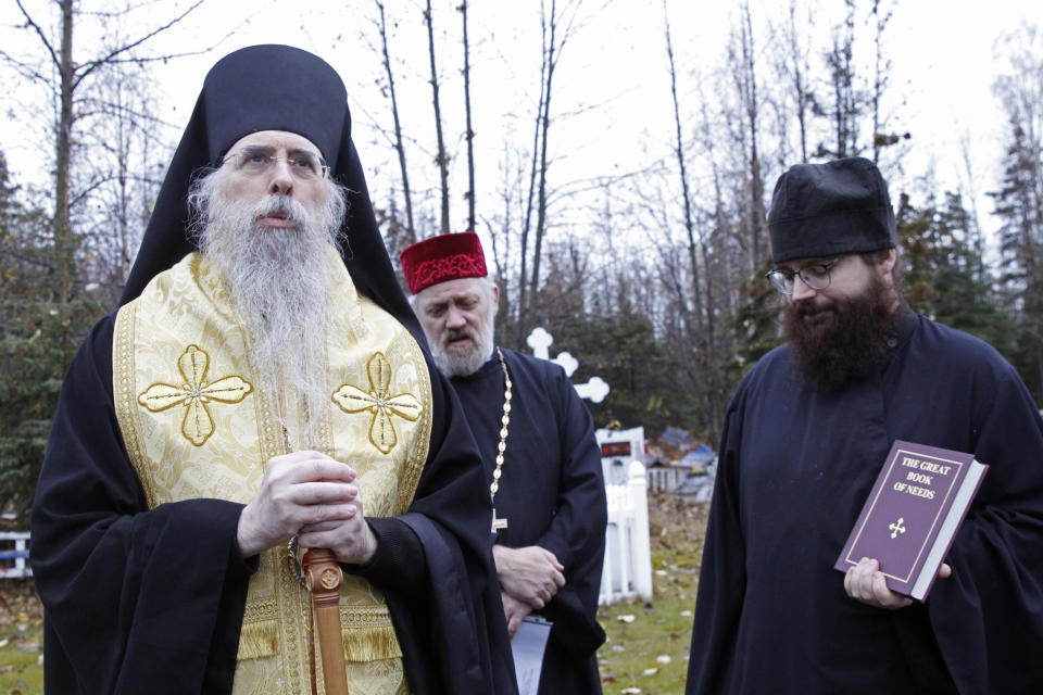 Bishop Alexei, left, the head of the Orthodox Church in Alaska, is shown Oct. 13, 2023, offering a prayer at a ceremony marking the beginning of a restoration project at the old St. Nicholas Church in Eklutna, Alaska. The Orthodox church is the oldest standing building in the Municipality of Anchorage. (AP Photo/Mark Thiessen)