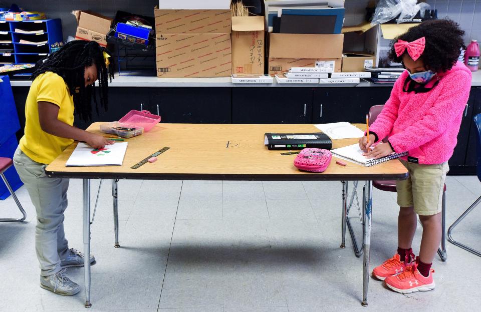 Audrianna Clay, left, and Gabriella DeLoach social distance as they draw during art class at Carver Elementary Arts Magnet School in Montgomery, Ala., on April 20.