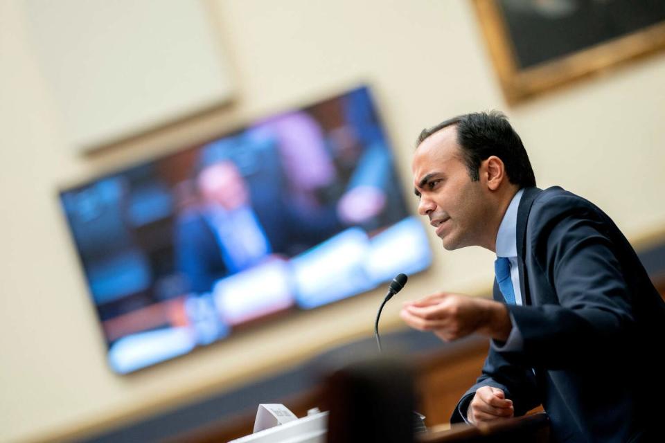 A man is shown in profile near a microphone.