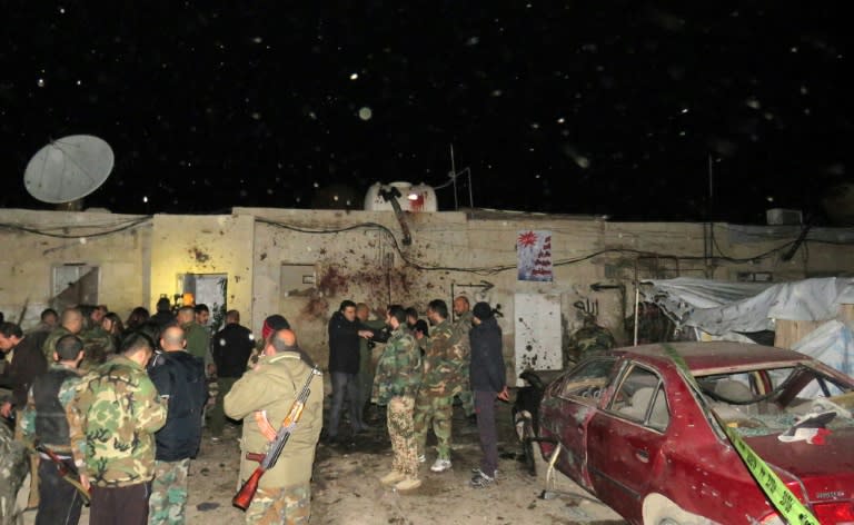 Syrian soldiers gather at the site of an attack in Kafr Sousa, southwest of the Syrian capital Damascus on January 12, 2017