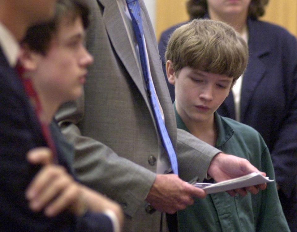 --11-15-02, 6aGary McCracken@PensacolaNewsJournal.com--Alex King, 13, reads notes held by his attorney, James Stokes, during announcement of the mediation outcome in the King brothers' murder case. Derek King,14, is at left.