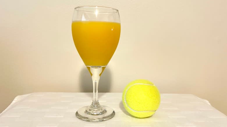 Orange juice and tennis ball