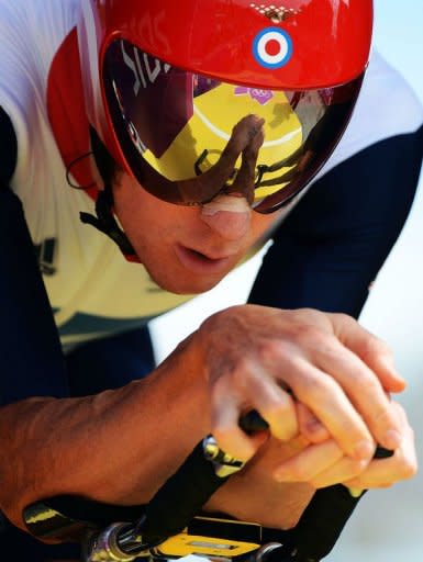 Britain's gold medalist Bradley Wiggins prepares to start competing in the London 2012 Olympic Games men's individual time trial road cycling event in London