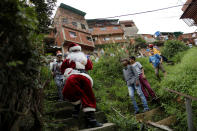 <p>A man dressed as Santa Claus walks in the slum of Petare in Caracas, Venezuela, Dec. 11, 2016. As the economic crisis makes food scarce for millions of Venezuelans, many families are simply canceling all Christmas plans. (Ueslei Marcelino/Reuters) </p>