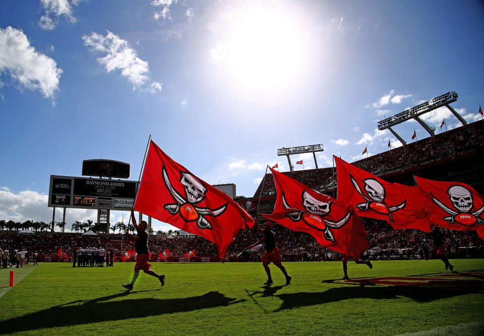 TAMPA, FL – DECEMBER 13: Tampa Bay Buccaneers flags are carried on the field after a touchdown during the first half of the game against the New Orleans Saints at Raymond James Stadium on December 13, 2015 in Tampa, Florida. (Photo by Rob Foldy/Getty Images)