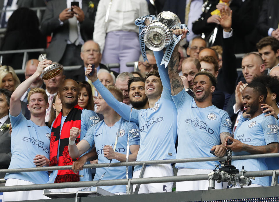 Manchester City players lift the trophy after the English FA Cup Final soccer match between Manchester City and Watford at Wembley stadium in London, Saturday, May 18, 2019. (AP Photo/Kirsty Wigglesworth)