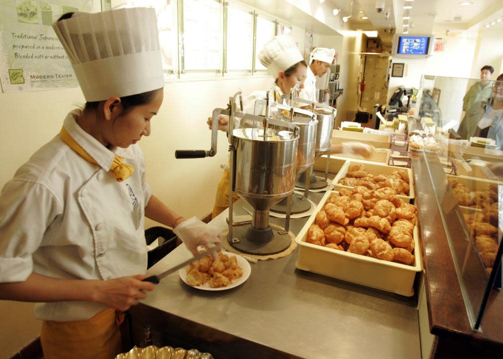 Chefs making cream puffs at Beard Papa's.