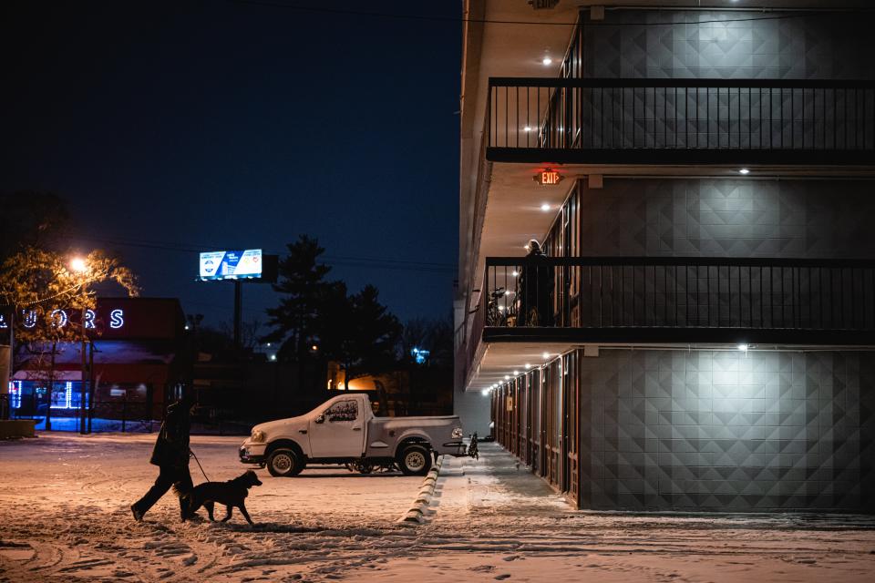 A person walks their dog through the parking lot of a hotel being used to house homeless individuals and families on December 23, 2022 in Louisville, Kentucky (Getty Images)