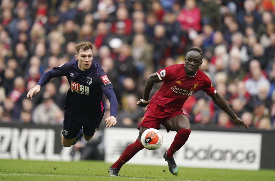 Liverpool's Sadio Mane, right, dribbles past Bournemouth's Jack Stacey during the English Premier League soccer match between Liverpool and Bournemouth at Anfield stadium in Liverpool, England, Saturday, March 7, 2020. (AP Photo/Jon Super)