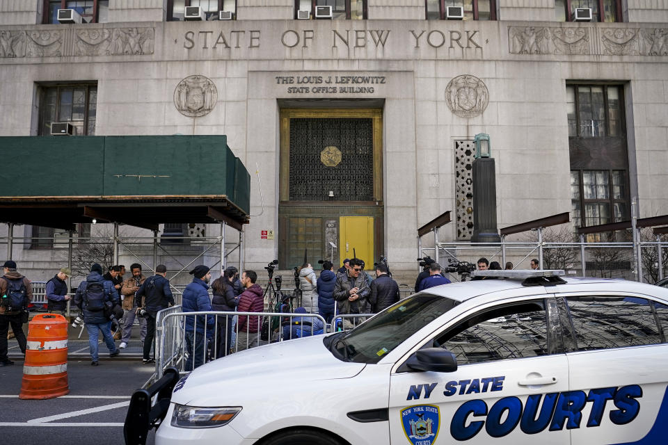 Journalists gather outside the public entrance to the 80 Centre Street building where a grand jury investigating former President Donald Trump over hush money payments is back in court and hearing evidence related to the case, Monday, March 27, 2023, in New York. It remains unclear when the panel might be asked to vote on whether to return an indictment. (AP Photo/John Minchillo)