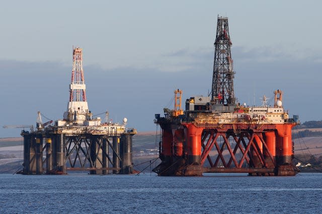 Two oil rigs anchored near the coastline