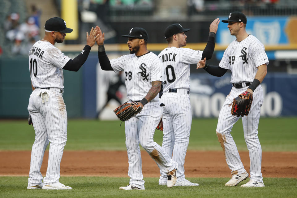 Chicago White Sox's Yoan Moncada (10), Leury Garcia (28), Danny Mendick (20) and Ryan Cordell (49) celebrate after defeating the Detroit Tigers in game one of a baseball doubleheader, Saturday, Sept. 28, 2019, in Chicago. (AP Photo/Kamil Krzaczynski)