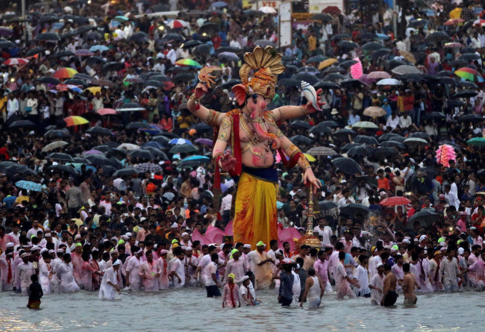 Devotees gather on the shores of the Arabian Sea