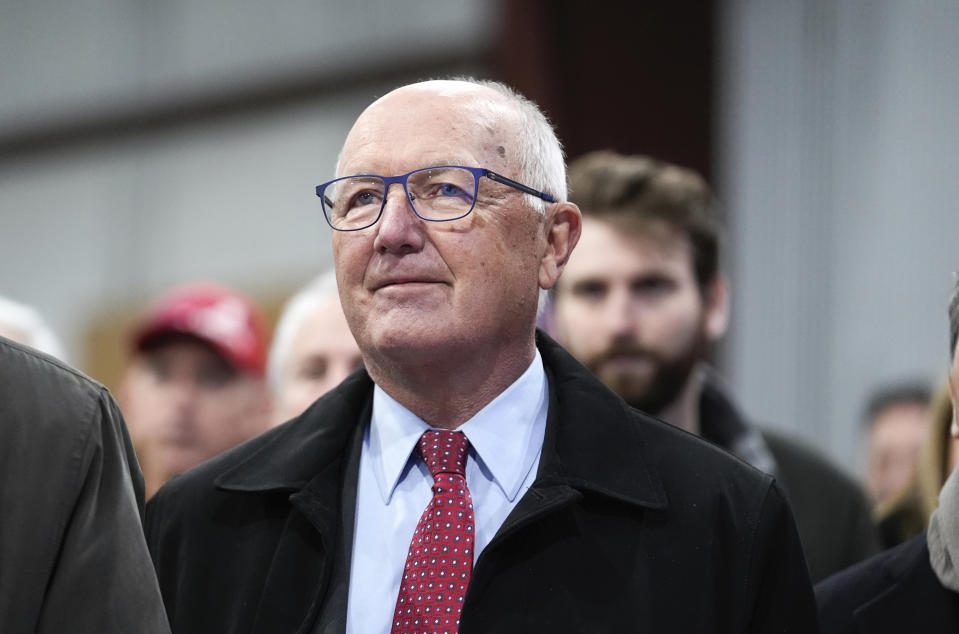 FILE - Michigan Republican Party chair Pete Hoekstra listens to Republican presidential candidate former President Donald Trump at a campaign rally in Waterford Township, Mich., Saturday, Feb. 17, 2024. Michigan Republicans are planning dueling presidential nominating conventions that will take place March 2, even though the national Republican Party said members properly removed former chair Kristina Karamo and recognized former Congressman Hoekstra as the party's new chair. Hoekstra announced Tuesday, Feb. 20, that he would hold a presidential nominating convention in Grand Rapids on the same day Karamo and her backers plan to hold one in Detroit. (AP Photo/Paul Sancya, File)