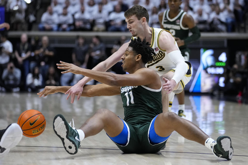 Michigan State guard A.J. Hoggard (11) and Purdue guard Braden Smith (3) go for a loose ball during the first half of an NCAA college basketball game in West Lafayette, Ind., Sunday, Jan. 29, 2023. (AP Photo/Michael Conroy)