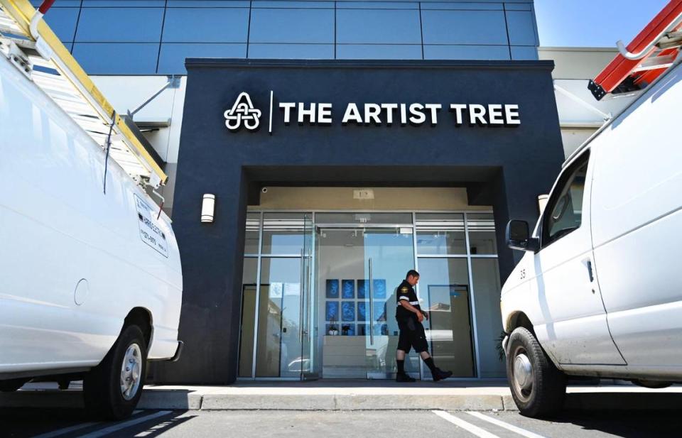 A security guard walks past The Artist Tree, a new cannabis dispensary opening next Monday, located at Palm and Nees Avenues. Artist Tree will double as an art gallery once opened. Photographed Wednesday, July 6, 2022 in Fresno.