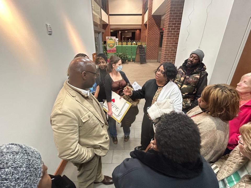 Petersburg Vice Mayor Darrin Hill, left, listens to Pastor Belinda Baugh of New Divine Worship Center outside a City Council meeting Tuesday, Feb. 6, 2024, at the Petersburg Public Library.