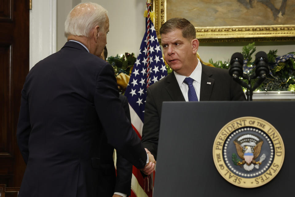 WASHINGTON, DC - DECEMBER 02: U.S. President Joe Biden (L) shakes hands with Labor Secretary Marty Walsh after signing bipartisan legislation averting a rail workers strike in the Roosevelt Room at the White House on December 02, 2022 in Washington, DC. Biden helped negotiate a deal between freight rail companies and their workers in September but a union that primarily represents conductors rejected the plan. Siting the need to avert the economic damage caused by a holiday season rail strike, Congress passed legislation imposing the negotiated agreement. (Photo by Chip Somodevilla/Getty Images)