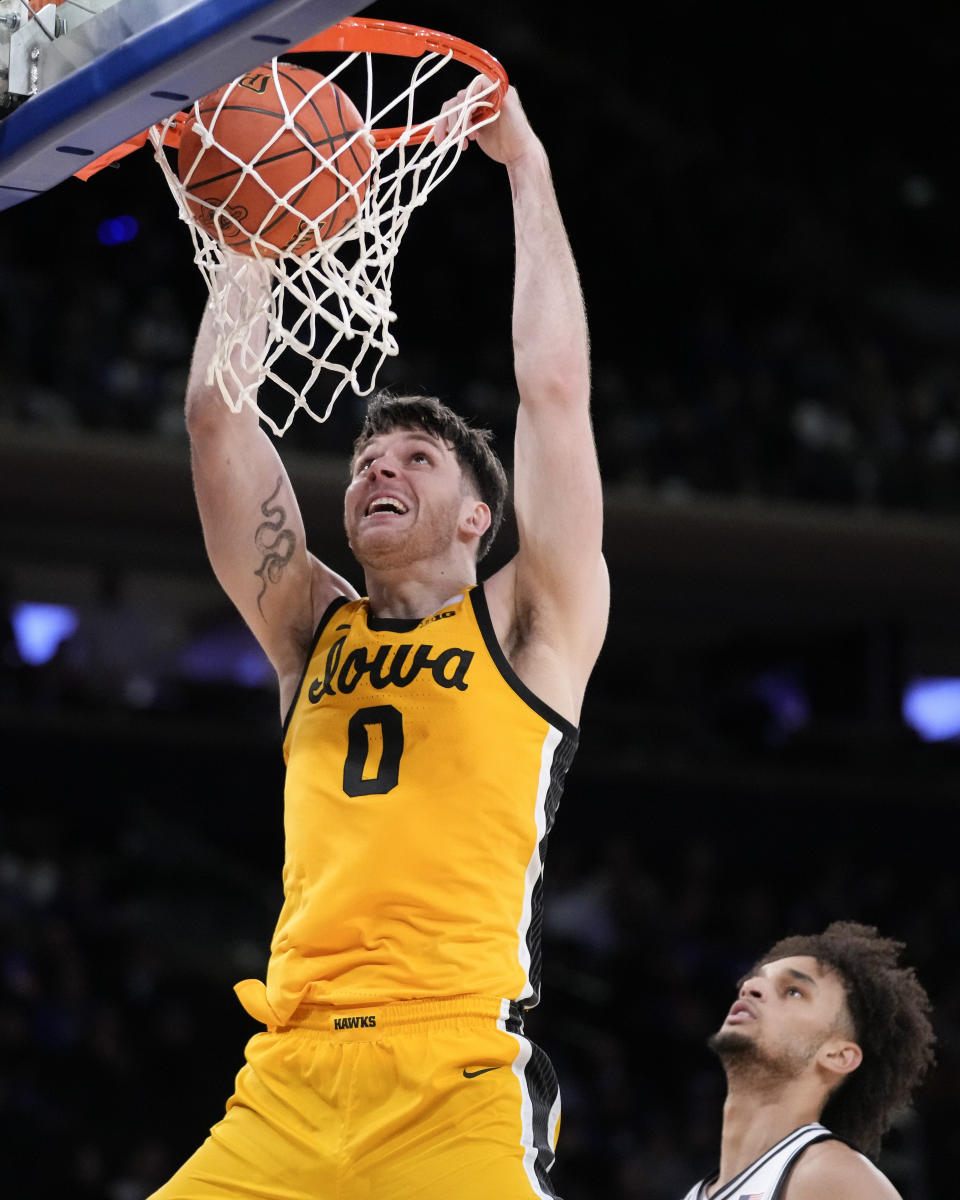 Iowa's Filip Rebraca (0) dunks during the second half of an NCAA college basketball game against Duke in the Jimmy V Classic, Tuesday, Dec. 6, 2022, in New York. (AP Photo/John Minchillo)