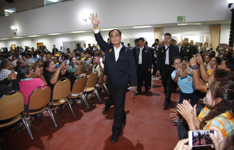 Prime Minister Prayuth Chan-ocha and candidate for the same position, waves to supporters as he attends a government-sponsored event in Nakhon Ratchasima, Thailand, Wednesday, March 13, 2019. Prayuth has been nominated by a pro-army political party to become prime minister again after the March 24 general election. (AP Photo/Sakchai Lalit)