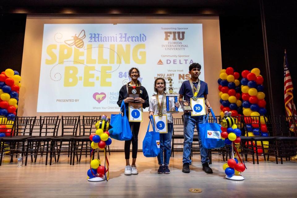 First Place winner Jasmine Perez from Bayview Elementary, center, second place winner Anvita Narasimhan from American Heritage School, left, and third place winner Stefano Carpio from Nativity Catholic School, right, react own stage after the Miami Herald Broward County Spelling Bee at NSU Art Museum in Fort Lauderdale, Florida on Thursday, March 7, 2024. D.A. Varela/dvarela@miamiherald.com