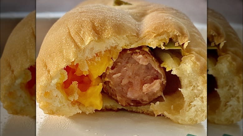 biscuit bomb cut in half with cheese and sausage