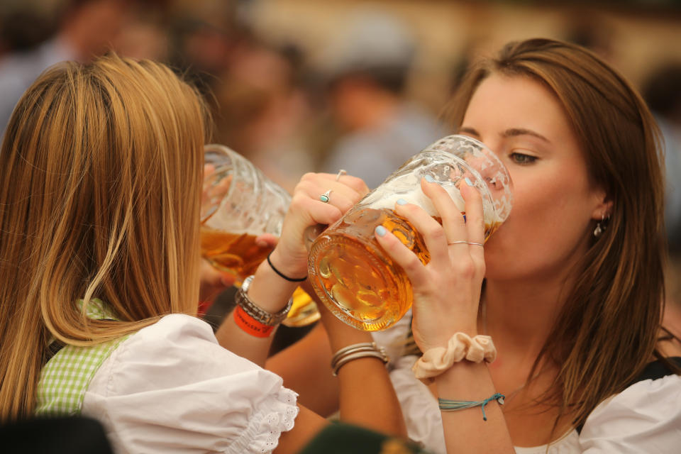 MUNICH, GERMANY - SEPTEMBER 21: Young women enjoy drinking beer out of  1-liter-mugs of beer during the opening weekend of the 2019 Oktoberfest on September 21, 2019 in Munich, Germany. This year's Oktoberfest, which will draw millions of visitors from all over the world, will run from October 21 through October 6. (Photo by Johannes Simon/Getty Images)