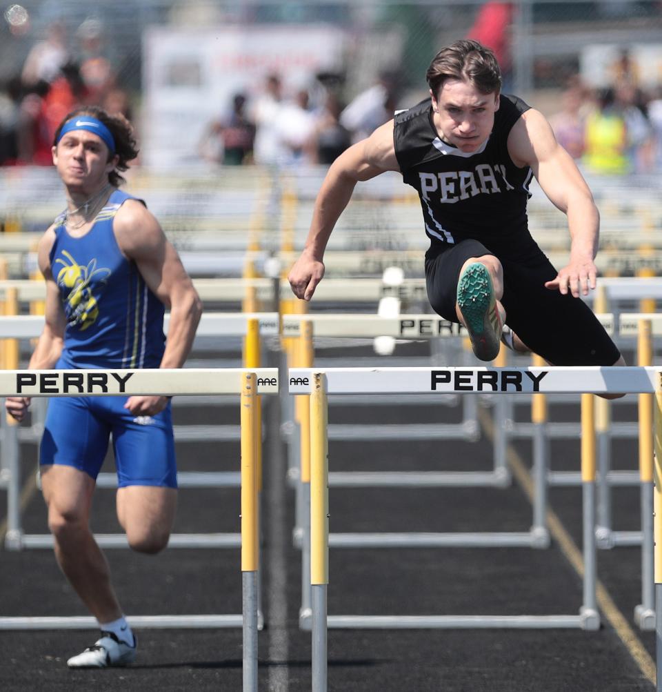 Garrett Laubacher of Perry heads to a first place in the 110 meter hurdles followed by East Canton's Brennan Betz at the Stark County Track and Field Championships held at Perry High School Saturday, April 23, 2022.