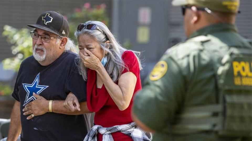 A woman cries as she leaves the Uvalde Civic Center in Uvalde, Texas, on Tuesday after an 18-year-old gunman opened fire at a Texas elementary school, killing at least 19 children.