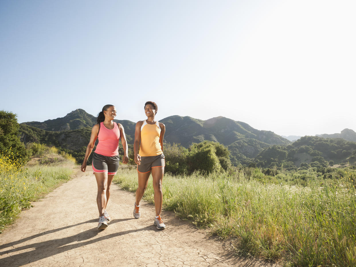 Two women walking on a trail.