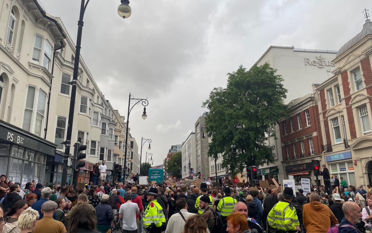 Demonstrators and police gather in Brighton