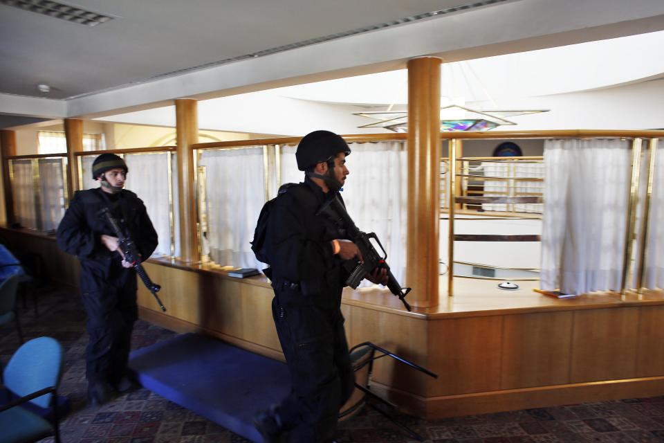 Israeli security personnel search a religious Jewish Yeshiva next to a synagogue, where a suspected Palestinian attack took place, in Jerusalem