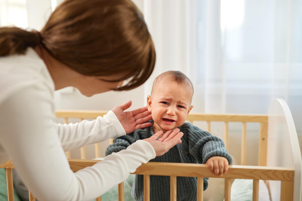 a baby crying in their crib