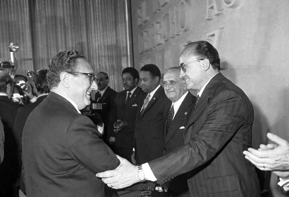 FILE - Mexican President Luis Echeverria congratulates Secretary of State Henry Kissinger after Kissinger's speech before the Latin American Foreign Ministers conference in Mexico City, Wednesday, Feb. 22, 1974. Leftists in Chile were tortured during the military dictatorship of Gen. Augusto Pinochet and in Argentina, many were "disappeared" by members of the brutal military dictatorship that held detainees in concentration camps. It all happened with the endorsement of Henry Kissinger, the former U.S. secretary of state. Many countries were scarred deeply during the Cold War by human rights abuses inflicted in the name of anti-communism and where many still harbor a deep distrust of their powerful neighbor to the north. (AP Photo, File)