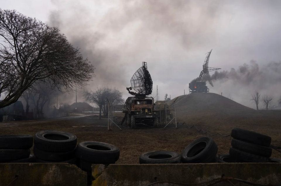 Smoke rises from an air defense site in the aftermath of an apparent Russian strike in Mariupol, Ukraine, on the first day of the conflict. <em>AP Photo/Evgeniy Maloletka</em>