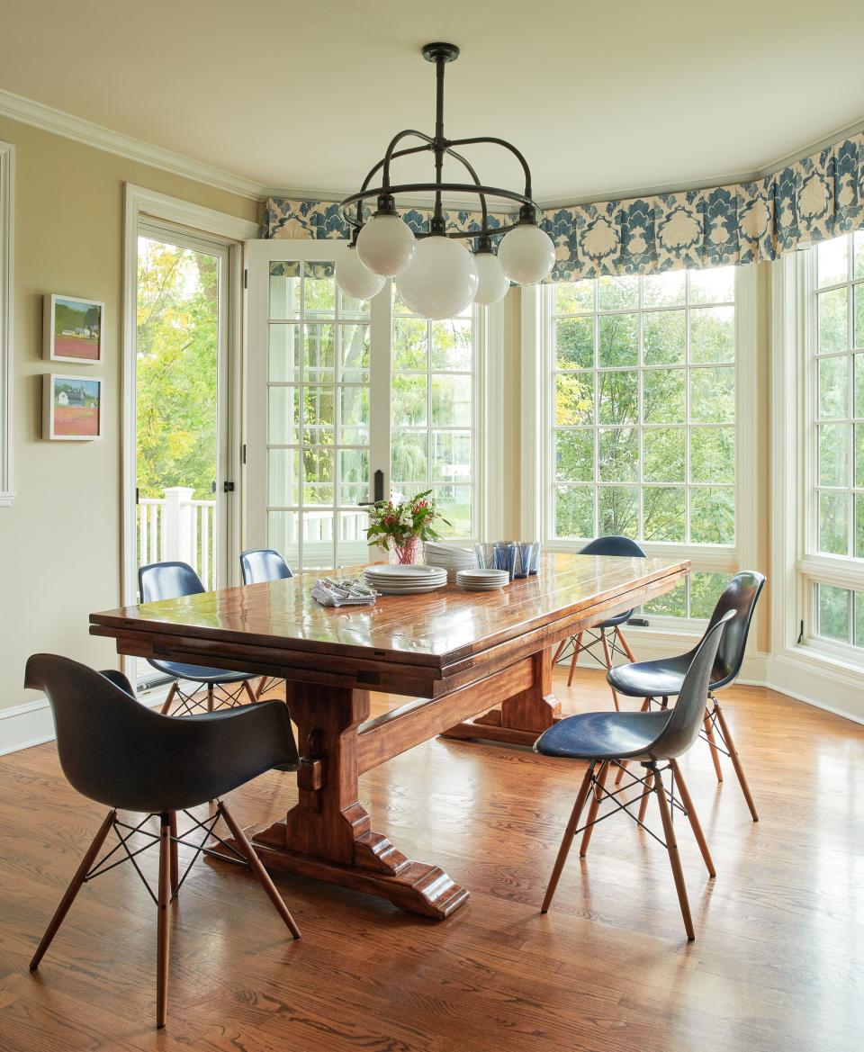 Ganley ordered the table, made of alder wood, from Bausman and Company. “A lot of furniture manufacturers use alder because it accepts stains so well,” says Brandi Hagen. “It’s a cherry stain.” The blue Eames chairs are similar to chairs the Ganleys had when they lived in London. Nina Campbell fabrics did the window treatments. The chandelier is by Ralph Lauren.