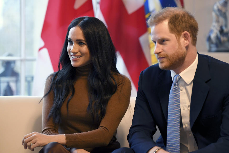 FILE - In this Tuesday, Jan. 7, 2020 file photo, Britain's Prince Harry and Meghan, Duchess of Sussex smile during their visit to Canada House, in London. Prince Harry and his wife Meghan 'stepping back' as senior UK royals, will work to become financially independent, they announced Wednesday, Jan. 8, 2020.(Daniel Leal-Olivas/Pool Photo via AP, file)